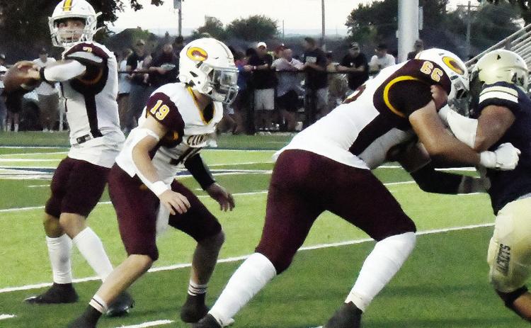 Clinton’s Easten Powell prepares to throw the ball while, No. 19 Dyson Moss comes to assist No. 66 Andre Lime with blocking a Kingfisher defender during the Red Tornadoes’ road game Friday against the Yellowjackets. CDN | John Kinsey