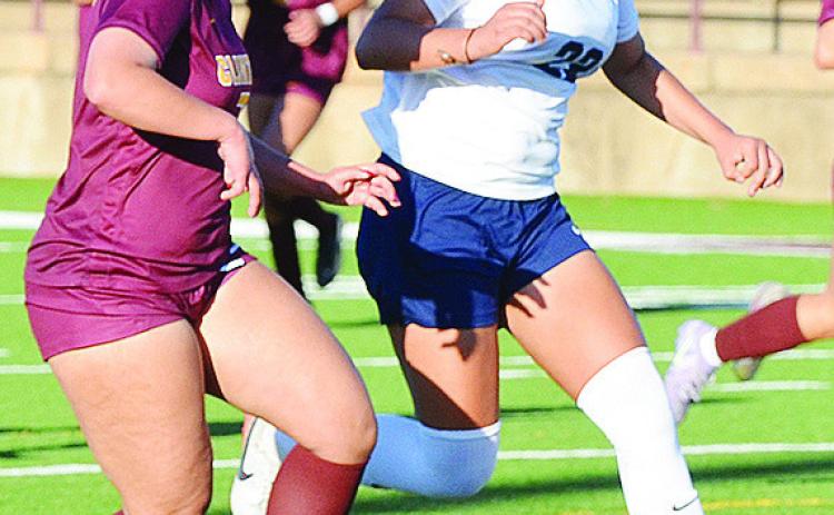 Clinton’s Lexie Conway, left, races against a Putnam City West player as she looks to score during the Lady Reds’ win in the Tornado Bowl. CDN | Sam Goodwyn