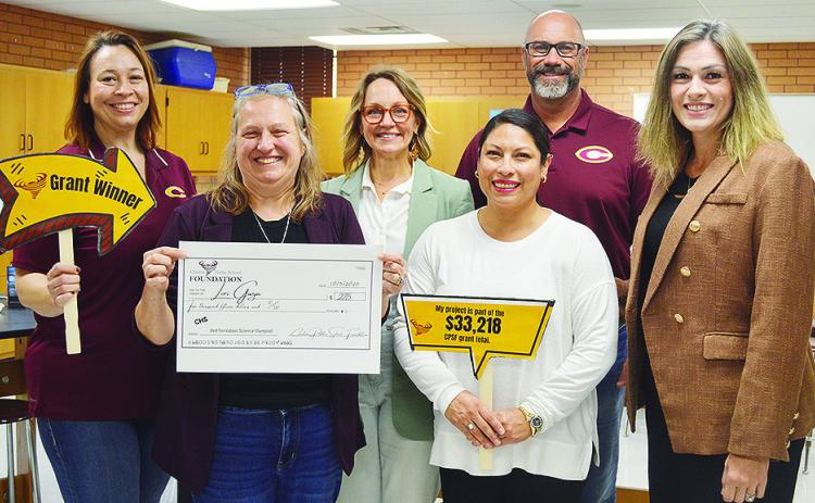 From left, Clinton Public Schools Asst. Supt. Melissa Knabe, Dr. Lori Gwyn, Clinton Public School Foundation Board Member Jenn Mosburg, Board Member Arleth Cifuentes, Supt. Nathan Meget, and Clinton High School Principal Michelle Sorter present Gwyn with