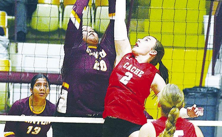 Clinton’s Aracelie Chavez goes up to meet the Cache player in an attempt to block her, while Karely Aguilar looks on during the Lady Reds’ match against the Lady Bulldogs Thursday in the Tornado Dome. CDN | Sam Goodwyn