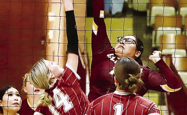 Clinton Ayshka Garcia reaches high above the net to hit it over the opponent during the Lady Reds’ Senior Night game against Blair in the Tornado Dome. CDN | Keri Staggs