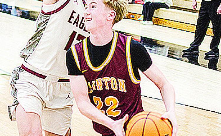 No. 21 Axl Deatherage drives against a defender as he heads toward the basket during Clinton’s playoff game Saturday in Weatherford. CDN | Sam Goodwyn