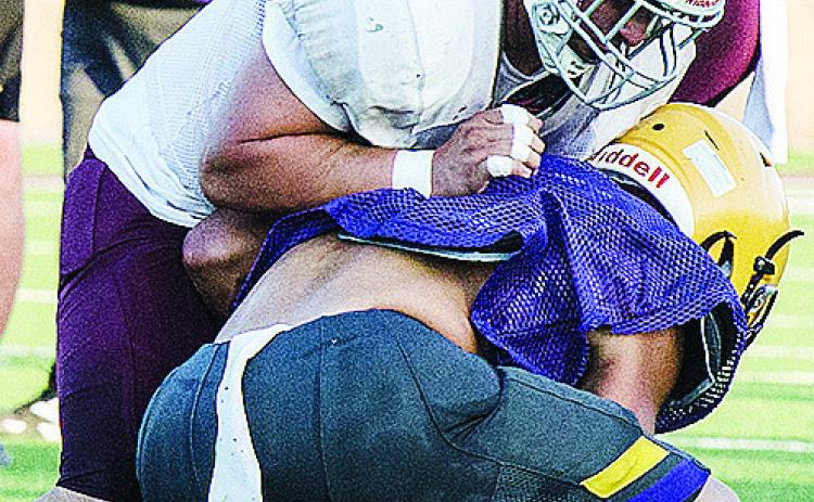Clinton’s Alex Amaya attempts to flatten the Anadarko defender as he blocks him during the Red Tornadoes’ scrimmage against the Warriors in the Tornado Bowl. CDN | Sam Goodwyn