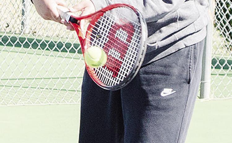 Makalya Bird return serves the ball during a recent practice at the Clinton High School tennis courts. CDN | Sam Goodwyn