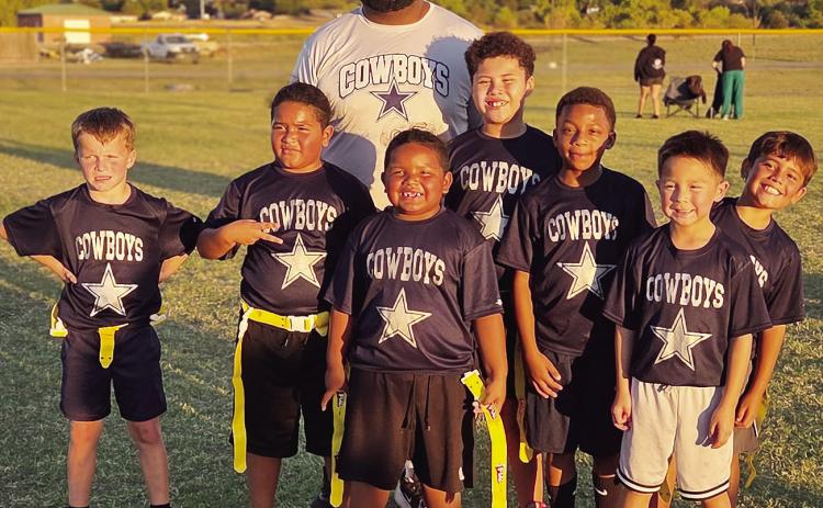The Cowboys youth flag football team smiles after participating in the flag football tournament Monday night at Schumacher Fields at Acme Brick Park. Pictured, in front, from left, are Khalil Douglas and Rance Randle; middle, Kolter Strahorn, Otha Douglas, Marcelo Juarez, Courage Fletcher and Kason Barron; back, Coach Otha Douglas. CDN |Courtesy Photo