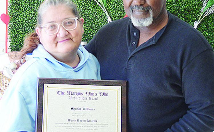 Shondra and Andre Williams of Nature’s Farm Girl show off their Marquis Who’s Who award. CDN | Courtesy photo