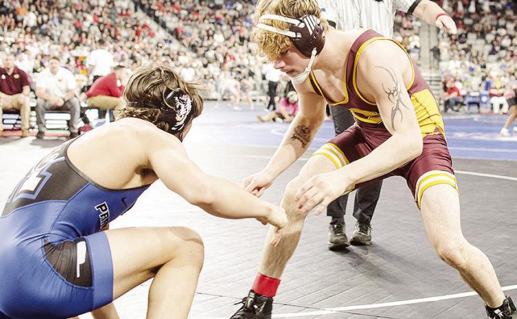 Clinton’s Landon Wilson, right, eyes an opening against his opponent from Harrah in Class 4A 165-pound weight class championship match Saturday at OG&amp;E Coliseum in Oklahoma City. CDN | Sam Goodwyn