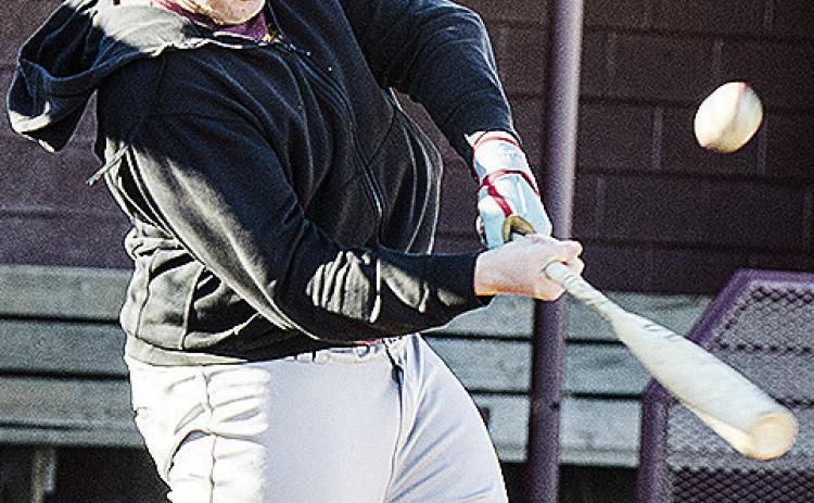 Clinton’s Dylan Hoffman hits the ball hard during practice at the baseball field. CDN | Sam Goodwyn