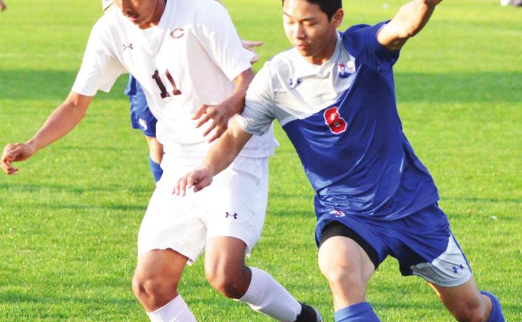 Clinton senior midfielder Roberto Solis fights to keep possession of the ball against Christian Heritage. CDN | Collin Wieder