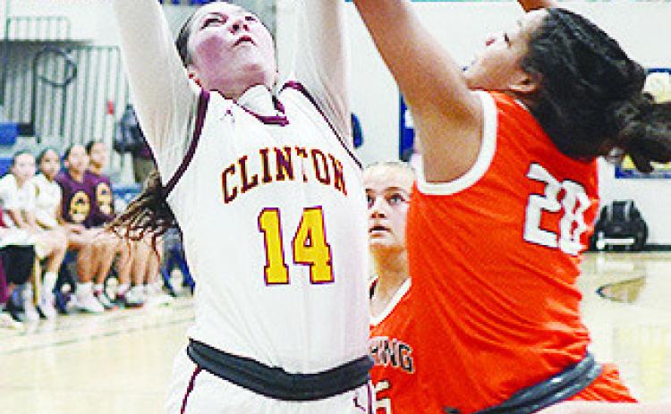 Clinton’s Brooklyn Aston attempts a layup against a Cushing defender in the Lady Reds’ playoff game against the Lady Tigers. CDN | Sam Goodwyn