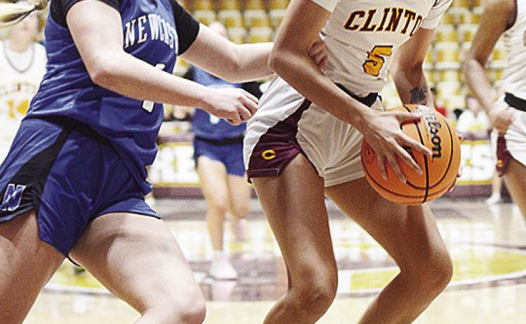 Clinton’s Lillian Lime braces to go up for a layup against a Newcastle defender during the Lady Reds’ basketball game against the Lady Racers in the Tornado Dome during the winter. CDN | Sam Goodwyn