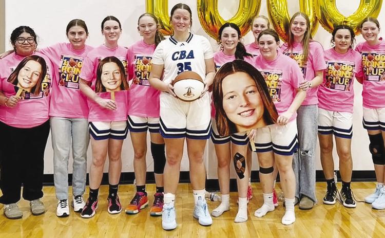 The Corn Bible Academy Lady Crusaders celebrate as Kate Stewart, center, scored her 1,000th career point for CBA on a threepoint shot during the Lady Crusaders’ 60-56 overtime loss last Friday to Pioneer-Pleasant Vale during the Burlington Tournament. P