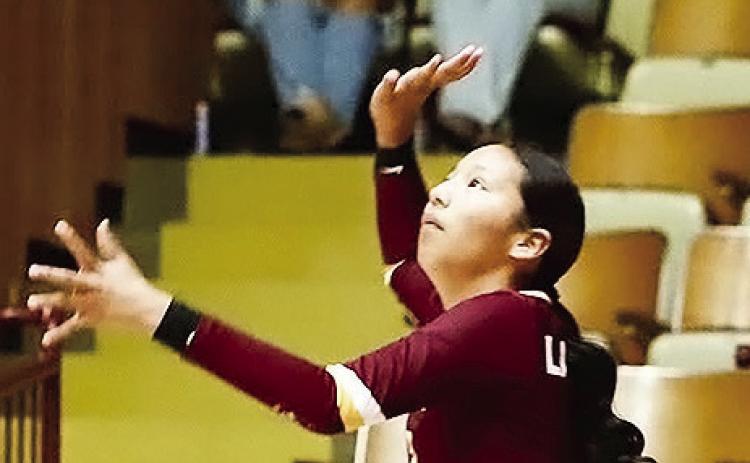 Clinton’s Ella Redshin focuses on the ball as she prepares to serve during the Lady Reds’ match against Blair in the Tornado Dome. CDN | Kerri Staggs