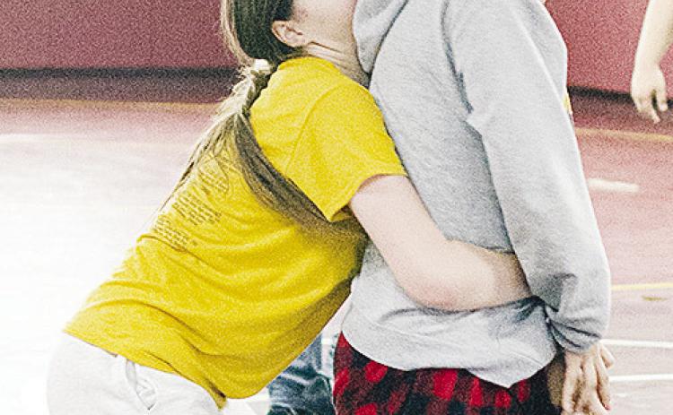 Clinton’s Aryana Pugh, left, grapples with Pricila Gutierrez-Banuelos in an open practice in the wrestling room during winter break. CDN | Sam Goodwyn
