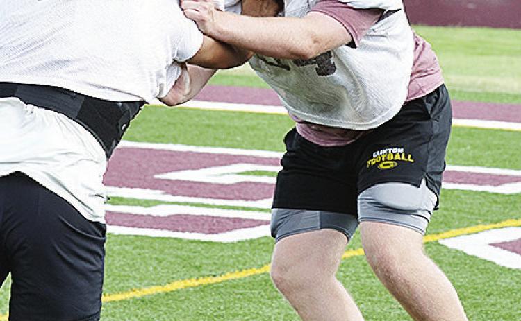 Clinton’s Connor Richardson, right, blocks No. 12 Aaron Ramirez during a practice in the Tornado Bowl. CDN | Sam Goodwyn