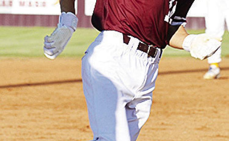 Clinton’s Snider Dowdell rounds third on his way home to score against Arapaho-Butler this summer. CDN | Sam Goodwyn