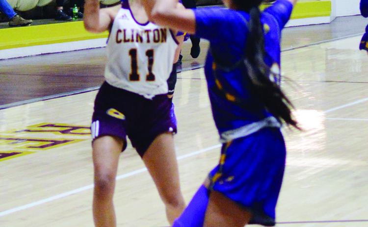 Clinton’s Rica Stennis looks for an opening to pass.