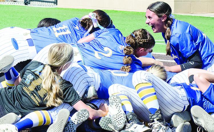 Arapaho-Butler’s Kyliee Brinkley, right, laughs on top of the dog pile after winning the 2026 Class A Fast-Pitch Softball State Championship Saturday at FireLake Ball Field in Shawnee. CDN | Sam Goodwyn