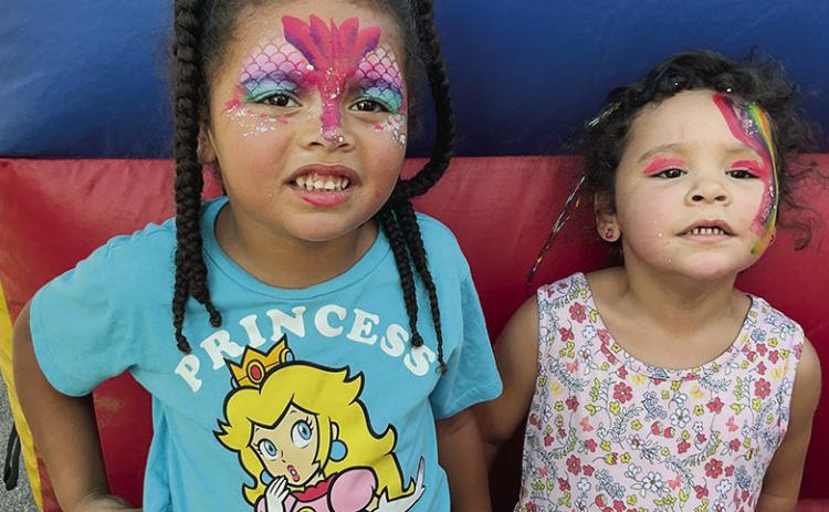 Mondessa Adams, left, and Destiny Lewis show off their fresh face paintings during the recent Back to School Bash at the 700 block of Frisco Avenue. CDN | Courtesy photo