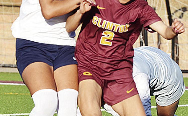 Clinton’s No. 2 Sammy Meraz battles with a Lady Patriot for control of the ball midway through the Lady Reds’ win over the Lady Patriots. CDN | Sam Goodwyn
