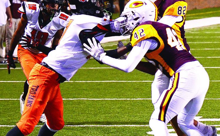 Clinton’s No. 42 CJ Begay and No. 82 Judd Hall block a defender during the Red Tornadoes’ game against the Trojans. CDN | Micah Ashcraft