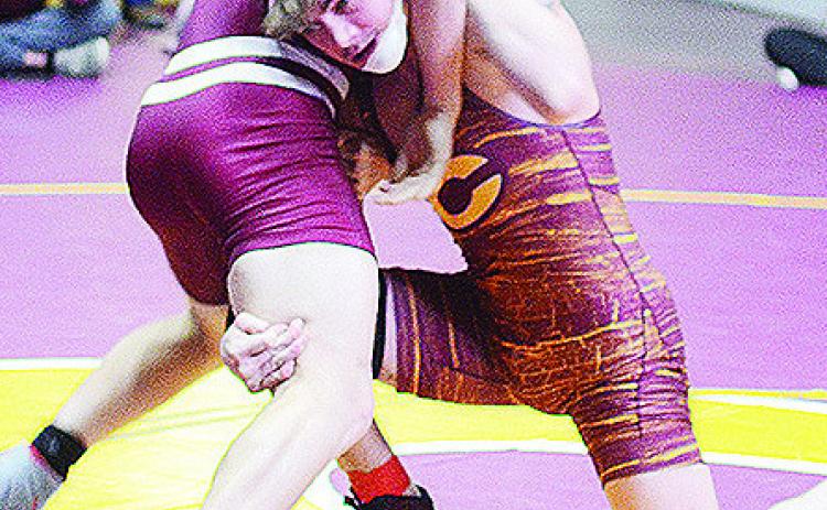 Clinton’s Landon Wilson, right, attempts a fireman’s carry of his opponent during the District Duals held at the Tornado Dome. CDN | Sam Goodwyn