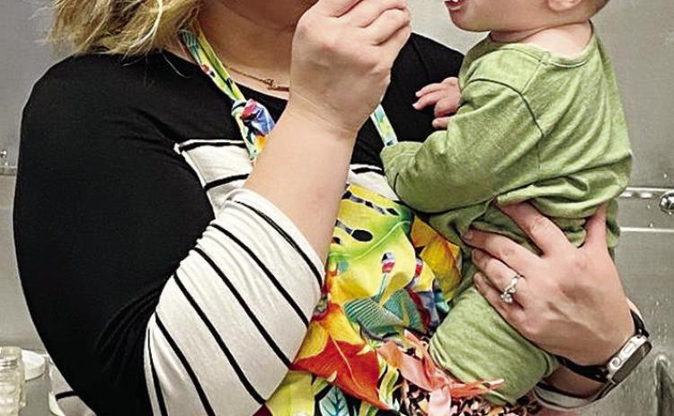 Merlanda Dorman offers a bite of mashed potatoes to her daughter, An-See nie, during Cornerstone Church’s annual Thanksgiving Feed. CDN | Staff Photo