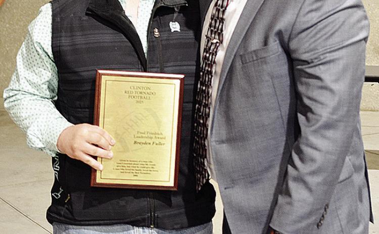 Brayden Fuller, left, poses with Coach John Higbee after being awarded the Fred Friedrich Leadership Award at the annual football banquet in the Frisco Center to end the season. CDN | Sam Goodwyn