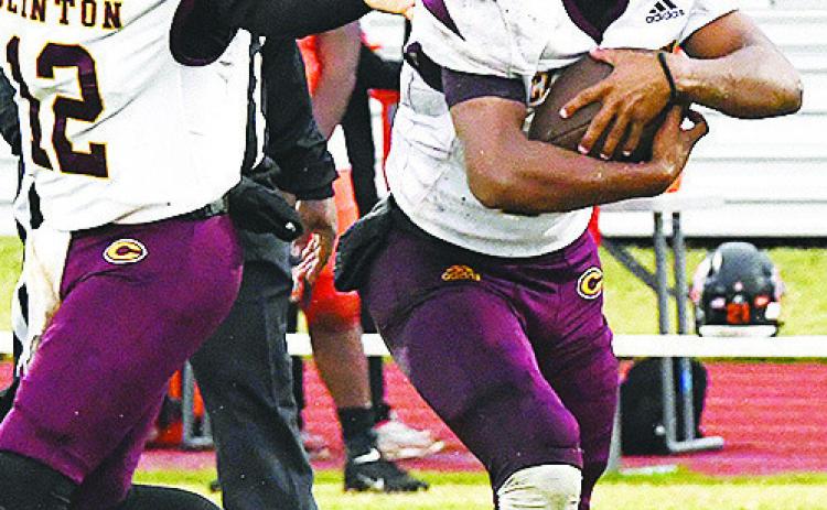 Clinton’s No. 10 Darius RomanNose takes the handoff from quarterback Sutton Hernandez during the Red Tornadoes’ regular season finale win over the Douglass Trojans in Oklahoma City. CDN | John Kinsey