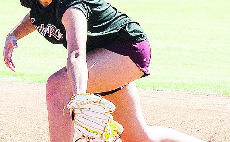 Clinton’s Reese Giblet back hands the ball as she goes through a fielding drill during practice at the high school softball field. CDN | Sam Goodwyn