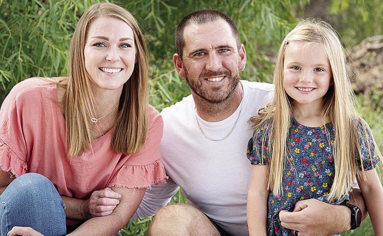 New Clinton Defensive Coordinator Skylar Watson, center, smiles with his wife Jannie, left, and daughter Journey, right. CDN | Courtesy photo