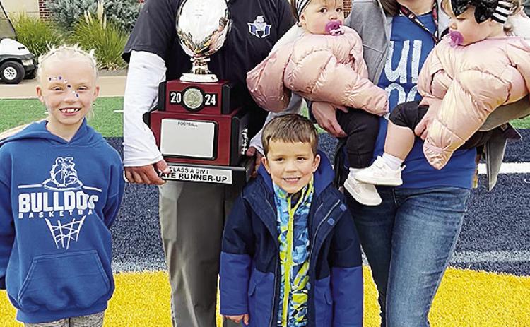Soon to be newly-appointed Clinton football coach Trevor Powers, center, smiles with his family after finishing as runner-up in the Class A State Championship game at UCO. Pictured, from left, are daughter Tenley, Powers, son Jet, wife Shayla and twin dau