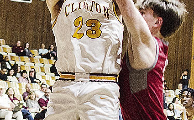 No. 23 Easten Powell jumps for the contested layup during Clinton’s regular season finale against Weatherford. CDN | Sam Goodwyn