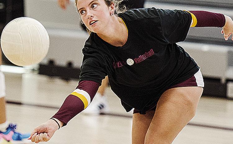 Clinton’s Lillian Heerwald reaches low for the ball during warm-ups prior to the Lady Reds’ first game in the Best of the West Tournament Friday in the new middle school gym. CDN | Sam Goodwyn
